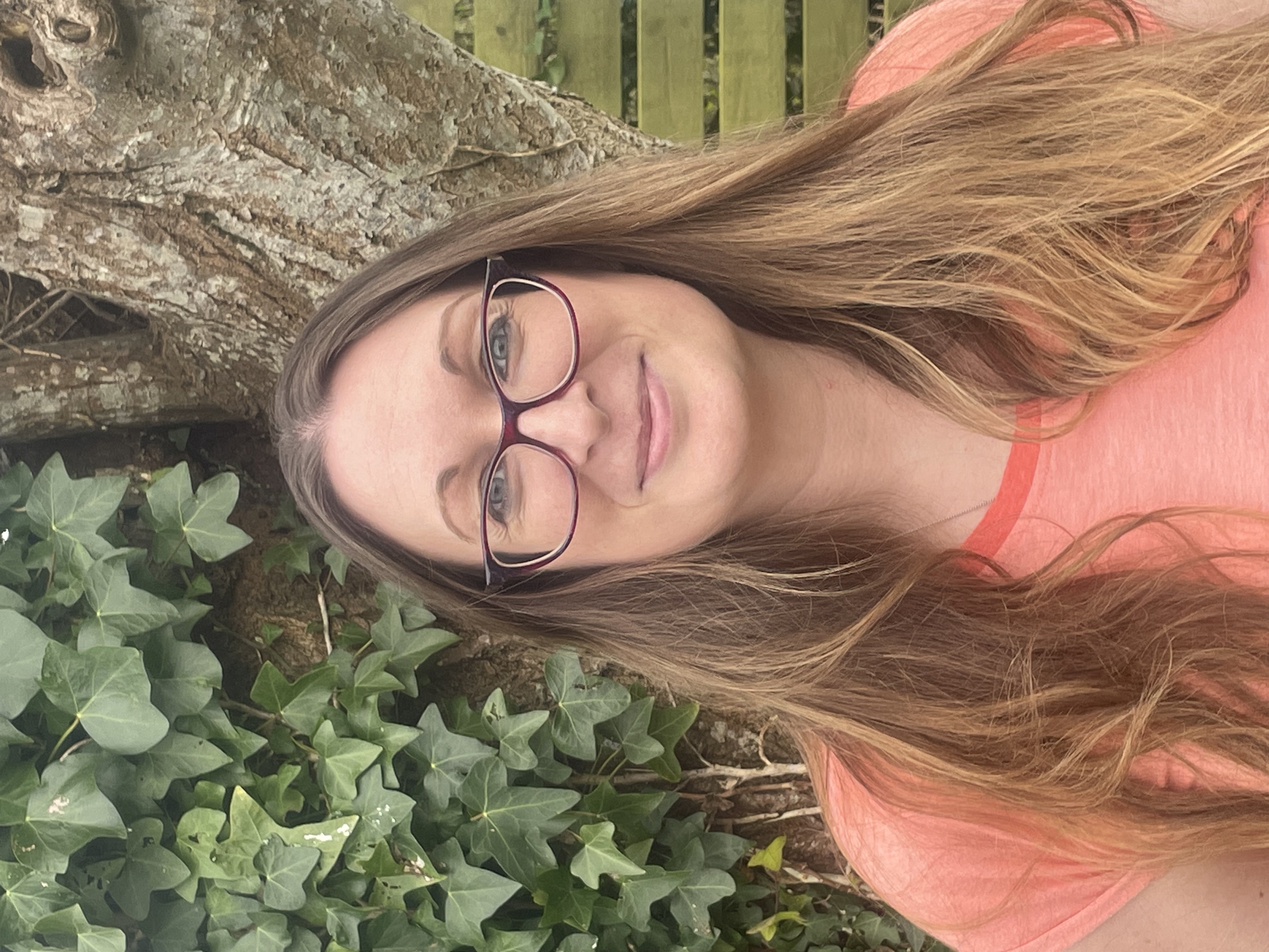 Danielle Curr of National Deaf Children's Society standing in front of a tree