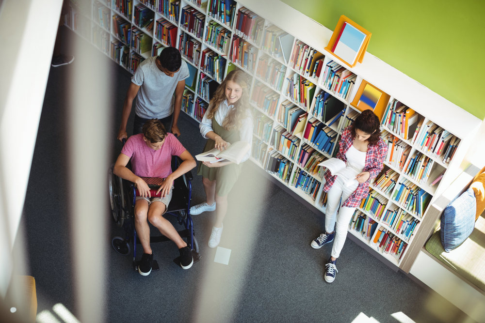 Aerial shot of a diverse group of young people in a library
