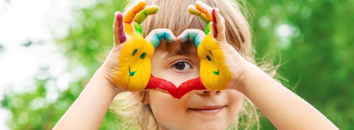 Girl Making Heart With Painted Hands