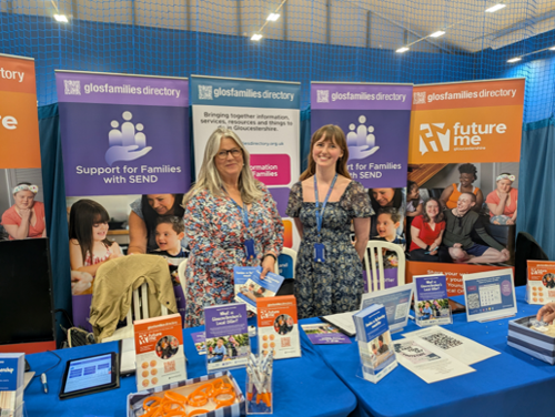 Glos County Council SEND Quality and Engagement team members on their 'stand'  at the Big Health Day 2026, with leaflets, banners and surveys along with pens and wristbands in view on the table