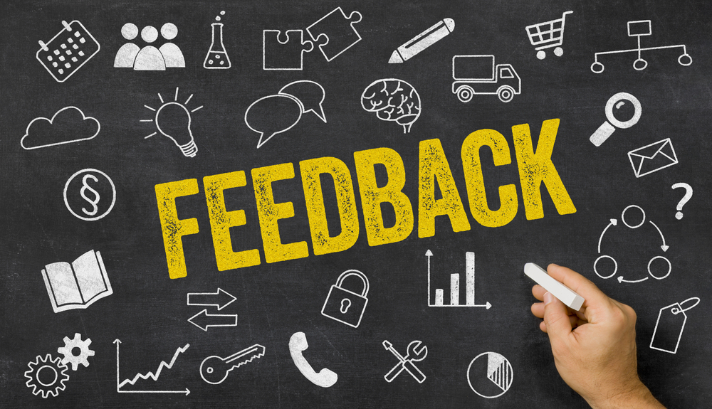 Feedback written on a blackboard with icons 