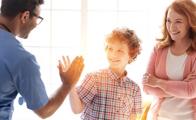 Young Teen Getting High Five from adult