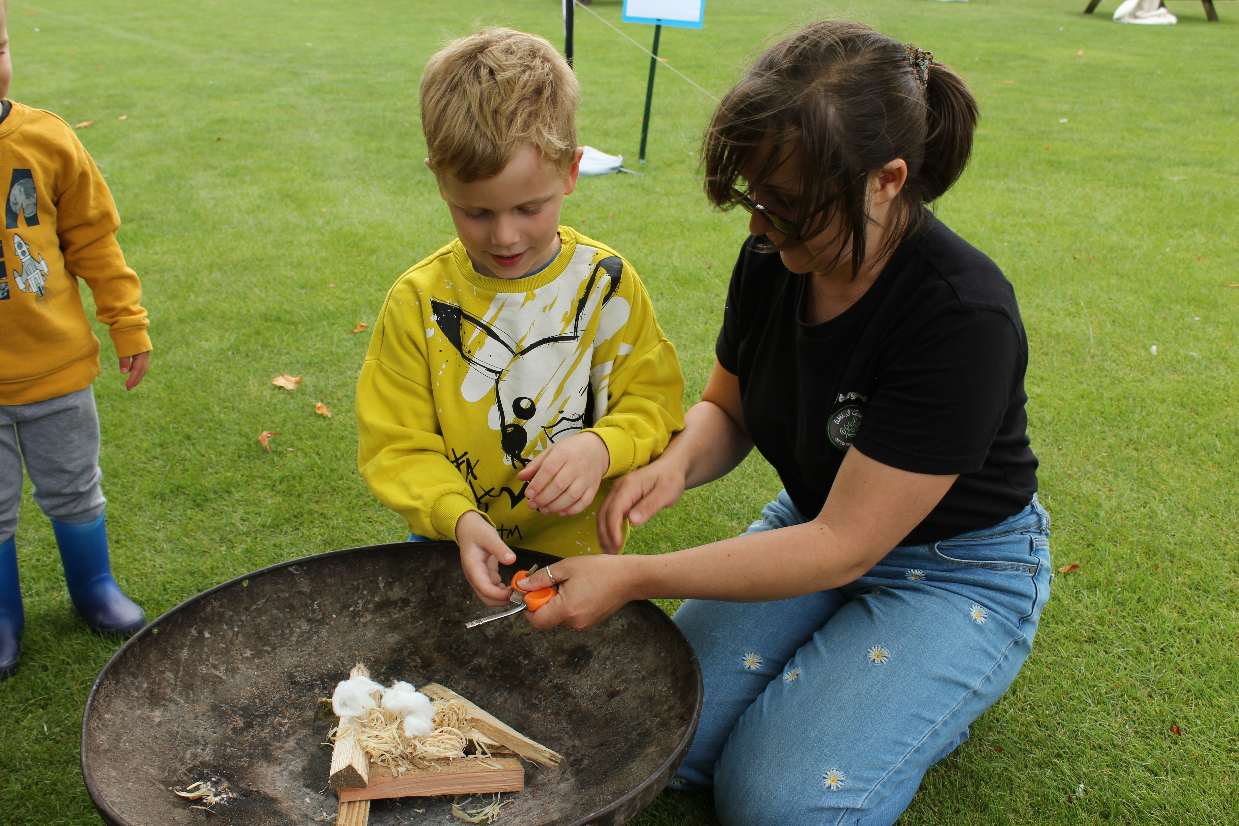 Child getting ready to toast marshmallows on outdoor fire