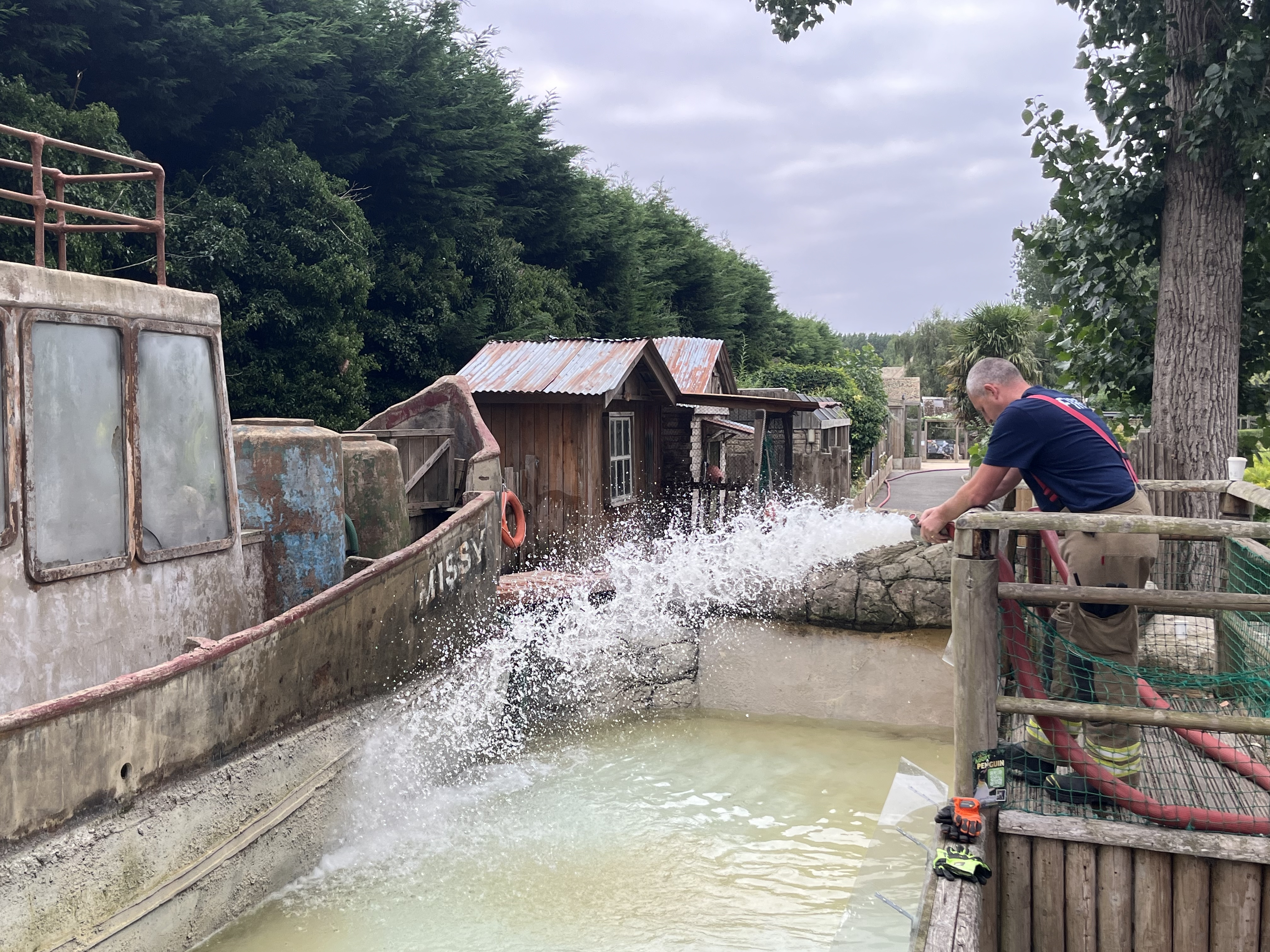 Gloucestershire Fire and Rescue Service teams help to refill Birdland's penguin pool