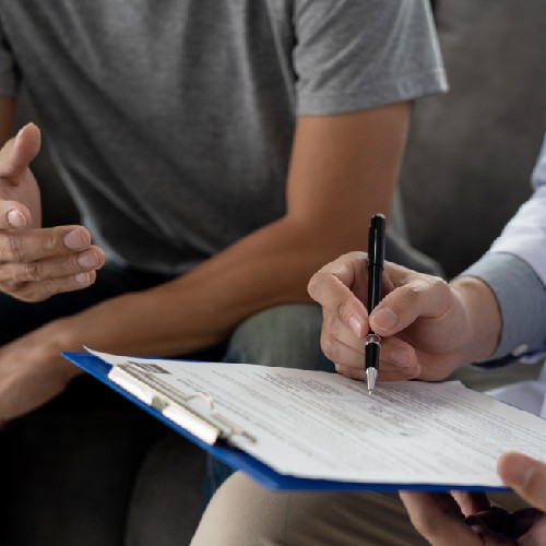 person writing on a form