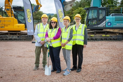 Image of Councillor Linda Cohen, Helen Bond and Kirsten Harrison and a representative from Carter Construction wearing high viz tabards with a spade in front of heavy plant at Wheatridge in August 2025