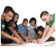 Group of people pointing to something on a piece of paper