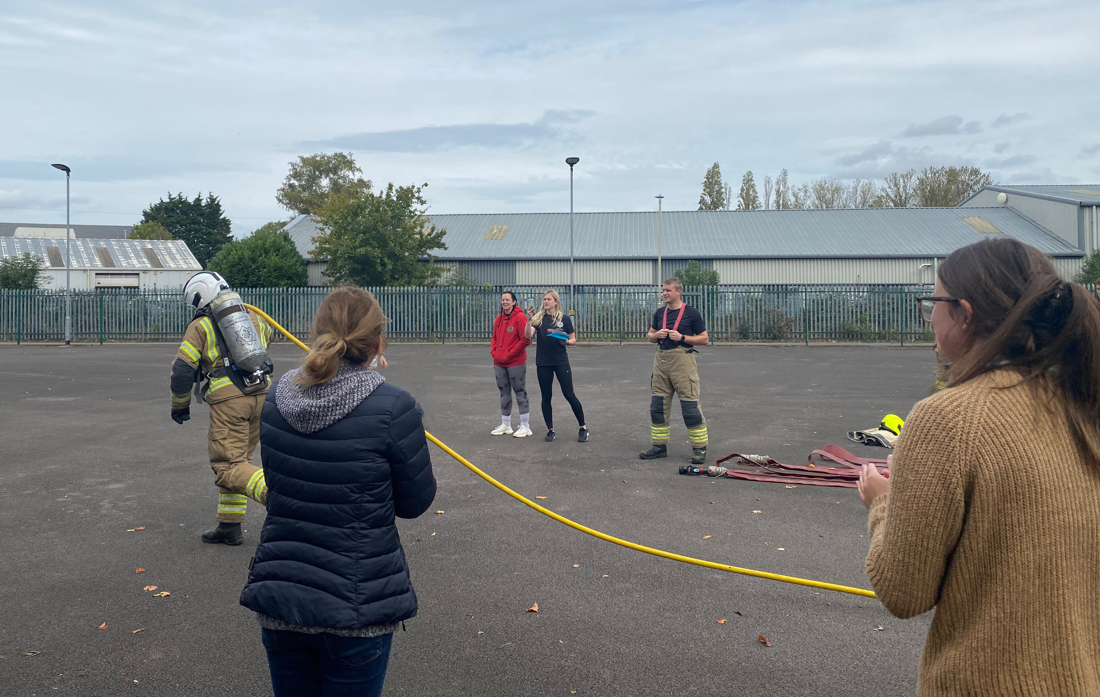 Staff cheering on colleagues in firefighter challenge