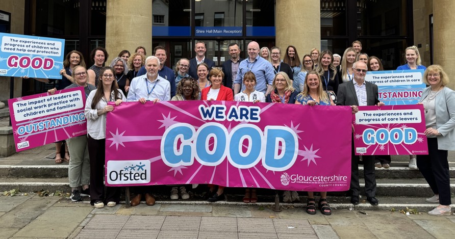group of staff with banner