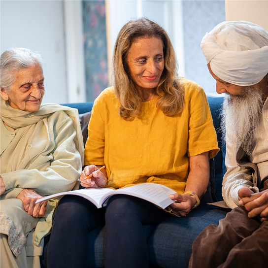 professional woman talking to people in their own home