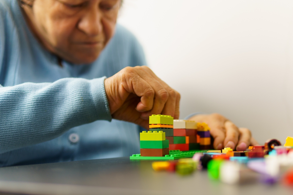 An image of an older person using lego